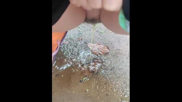 Girl Peed Desperately in the Rain to the Puddle